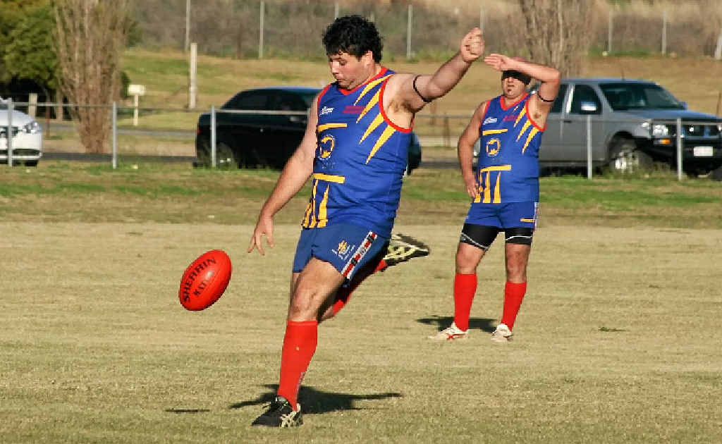 Dave Walker kicks downfield in a Redbacks Aussie rules victory.